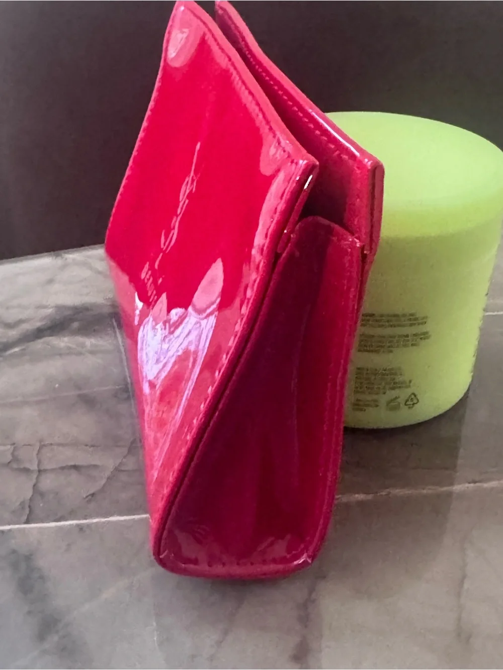 This is a bright red patent PVC Yves Saint Laurent Beauté cosmetic bag featuring